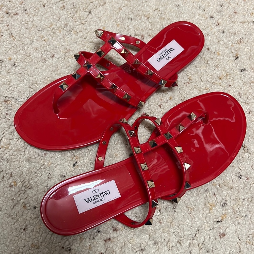 Bright red Valentino jelly sandals with shiny gold studs